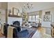 Bright living room features a white brick fireplace, wood mantel, and hardwood flooring at 375 Darren Dr, Fayetteville, GA 30215