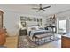 Spacious main bedroom with a ceiling fan, neutral walls, french doors, and decorative accents at 375 Darren Dr, Fayetteville, GA 30215