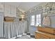 Charming mudroom with wainscoting, whimsical wallpaper, storage bench, and black and white checkered floors at 375 Darren Dr, Fayetteville, GA 30215