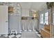 Charming mudroom with wainscoting, whimsical wallpaper, storage, and black and white checkered floors at 375 Darren Dr, Fayetteville, GA 30215