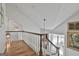 Staircase with hardwood floors, white railings, and a view of the second floor at 375 Darren Dr, Fayetteville, GA 30215