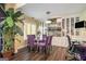 Dining area features a glass table, purple chairs, built-in shelving, and a large potted plant at 3192 Paces Mill Se Rd, Atlanta, GA 30339
