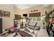 This home gym boasts modern exercise equipment, a mounted TV, and natural light from the large window at 3192 Paces Mill Se Rd, Atlanta, GA 30339