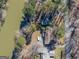 An aerial view of the property with lake frontage amongst lush trees, featuring a private driveway at 2545 Rockbridge Nw Rd, Conyers, GA 30012