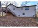 Exterior view of the back of the home with a wooden deck and stairwell at 387 Pine Trail, Canton, GA 30115