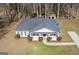 Aerial view of a single-story home with a well-maintained yard, set on a treed lot at 505 Phillips Dr, Palmetto, GA 30268