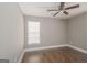 Bedroom featuring hardwood floors, a ceiling fan, neutral walls, and a window at 505 Phillips Dr, Palmetto, GA 30268