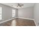 Bedroom with ceiling fan, two windows with blinds, and hardwood floors at 505 Phillips Dr, Palmetto, GA 30268