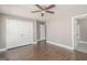 Bedroom with closet, ceiling fan, wood-look floors, and ensuite bathroom access at 505 Phillips Dr, Palmetto, GA 30268