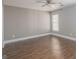 Bedroom with a window, hardwood floors, neutral walls, and a ceiling fan at 505 Phillips Dr, Palmetto, GA 30268
