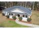 Angled view showcasing well-manicured lawn and inviting front porch of this cozy home at 505 Phillips Dr, Palmetto, GA 30268