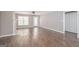Spacious living room with a decorative fireplace, ceiling fan, and wood-look floors at 505 Phillips Dr, Palmetto, GA 30268