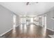 Open-concept living room with wood-look floors connecting to a kitchen with white cabinets at 505 Phillips Dr, Palmetto, GA 30268