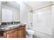 Well-maintained bathroom featuring a granite vanity, white toilet, and a shower-tub combo at 603 Honey Creek Rd, Mcdonough, GA 30252