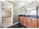 Double vanity bathroom with dark countertop cabinets and large mirror at 603 Honey Creek Rd, Mcdonough, GA 30252