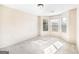 Neutral-toned room with bay windows, carpet flooring, and ample natural light at 603 Honey Creek Rd, Mcdonough, GA 30252