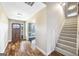 Bright foyer featuring hardwood floors, staircase, and a view into the living room at 603 Honey Creek Rd, Mcdonough, GA 30252