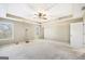 Spacious main bedroom with plush carpet, ceiling fan, and lots of natural light at 603 Honey Creek Rd, Mcdonough, GA 30252