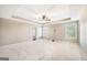 Expansive main bedroom with a ceiling fan, carpet flooring, and ample natural light at 603 Honey Creek Rd, Mcdonough, GA 30252