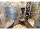 Walk-in stone shower featuring built-in seating, shelves, and rainfall shower head at 603 Honey Creek Rd, Mcdonough, GA 30252