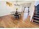 Inviting dining area features hardwood floors, modern chandelier, and flows into the adjacent living spaces at 2019 Chelton Se Way, Smyrna, GA 30080