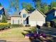 Charming two-story home features a manicured lawn, inviting front porch, and attached two car garage at 2019 Chelton Se Way, Smyrna, GA 30080