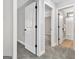 Hallway with gray walls and carpet flooring, leading to bedrooms and bathroom at 722 Gittings Ave, Peachtree City, GA 30269