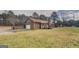 Spacious backyard featuring wood home, a garage, a deck, and a well-maintained lawn at 5687 Highway 212 N, Covington, GA 30016