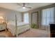 Inviting bedroom with a four-poster bed, neutral walls, and bright natural light at 5687 Highway 212 N, Covington, GA 30016