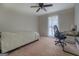 Bright bedroom with neutral walls, cozy bed, and a dedicated workspace area at 5687 Highway 212 N, Covington, GA 30016