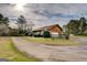 Exterior view of the home featuring a long driveway and detached garage at 5687 Highway 212 N, Covington, GA 30016