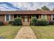 Inviting front entrance with wooden porch, leading to a charming home exterior at 5687 Highway 212 N, Covington, GA 30016