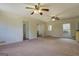 Open living room with carpet and neutral colors, adjacent to dining and kitchen areas at 5687 Highway 212 N, Covington, GA 30016