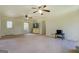 Bright living room with neutral walls, carpet flooring and multiple ceiling fans at 5687 Highway 212 N, Covington, GA 30016