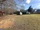 View of backyard featuring an open lawn area and two sheds providing additional storage at 650 Harris Dr, Locust Grove, GA 30248