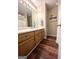 Bathroom featuring wood-look floors, cabinets, modern mirror and vanity lighting at 650 Harris Dr, Locust Grove, GA 30248