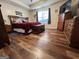 Bedroom featuring wood-look floors and a comfortable bed and matching dressers at 650 Harris Dr, Locust Grove, GA 30248