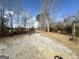 Long driveway leading to property surrounded by bare trees and sparse underbrush at 650 Harris Dr, Locust Grove, GA 30248