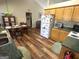 Kitchen featuring wood cabinets, breakfast nook, and wood-look flooring at 650 Harris Dr, Locust Grove, GA 30248