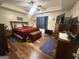 Primary bedroom featuring wood furniture, ceiling fan, and wood-look flooring at 650 Harris Dr, Locust Grove, GA 30248