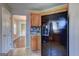 View of kitchen featuring wooden cabinets, tile floors, and stainless-steel refrigerator at 205 Siesta Key Ct, Locust Grove, GA 30248