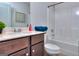 Well-lit bathroom featuring a modern vanity with a white countertop, a sink, and a combined tub and shower at 11118 Benton Dr # F5, Covington, GA 30014