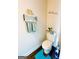 Cozy powder room featuring wood floors, decorative shelving, and a wall decal at 11118 Benton Dr # F5, Covington, GA 30014