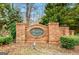 Neighborhood entrance sign for Benton Woods with brick facade and mature landscaping at 11118 Benton Dr # F5, Covington, GA 30014