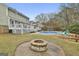 Backyard with in-ground fire pit, swimming pool and deck, perfect for outdoor living and entertaining at 100 Spincast Ct, Peachtree City, GA 30269