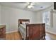 Bedroom featuring hardwood floors and a decorative wood bed frame with a window providing natural light at 100 Spincast Ct, Peachtree City, GA 30269