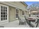 Outdoor deck featuring comfortable seating around a fire pit with a view of the landscaped yard at 100 Spincast Ct, Peachtree City, GA 30269