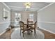 Cozy dining room with coffered ceiling, hardwood floors, and plenty of natural light at 100 Spincast Ct, Peachtree City, GA 30269