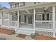 Welcoming front porch featuring a covered seating area, perfect for relaxing and enjoying the outdoors at 100 Spincast Ct, Peachtree City, GA 30269