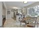 Bright kitchen with white cabinetry, tile floors, and breakfast bar at 100 Spincast Ct, Peachtree City, GA 30269